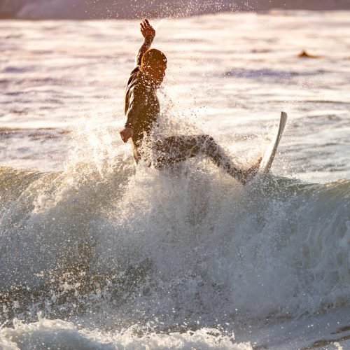 Surfer in action at sunset. Furadouro beach, Ovar - Portugal.